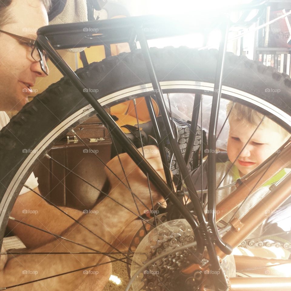 fixing bikes. my son and husband fixing up the bikes for the first ride of the spring.  