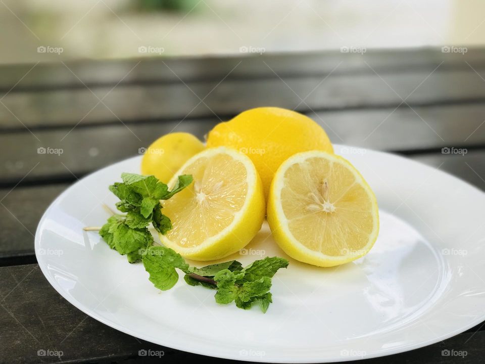 Two pieces of lemon and mint leaves perfect treat for summer.