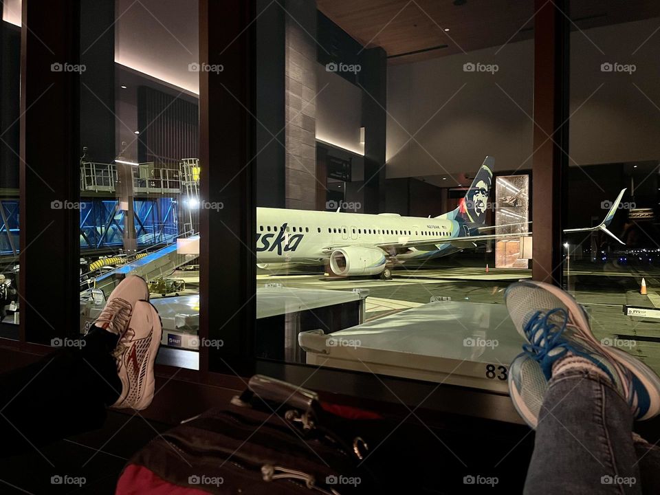 People legs on the airport window background 