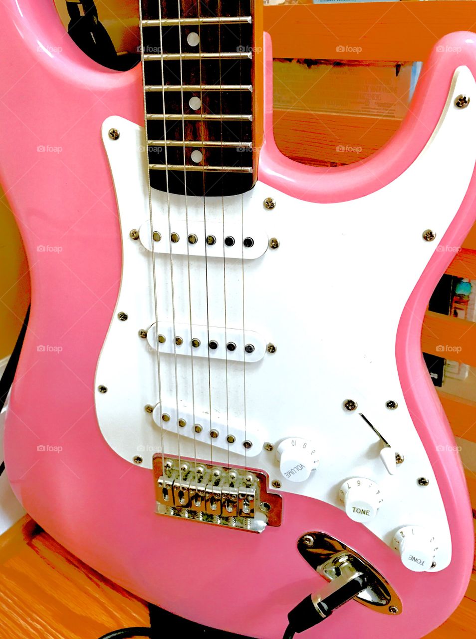 Pink electronic guitar