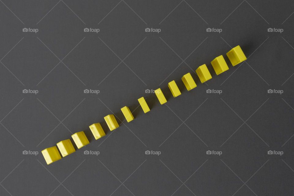 Many identical, repeating yellow rectangles on a gray background.