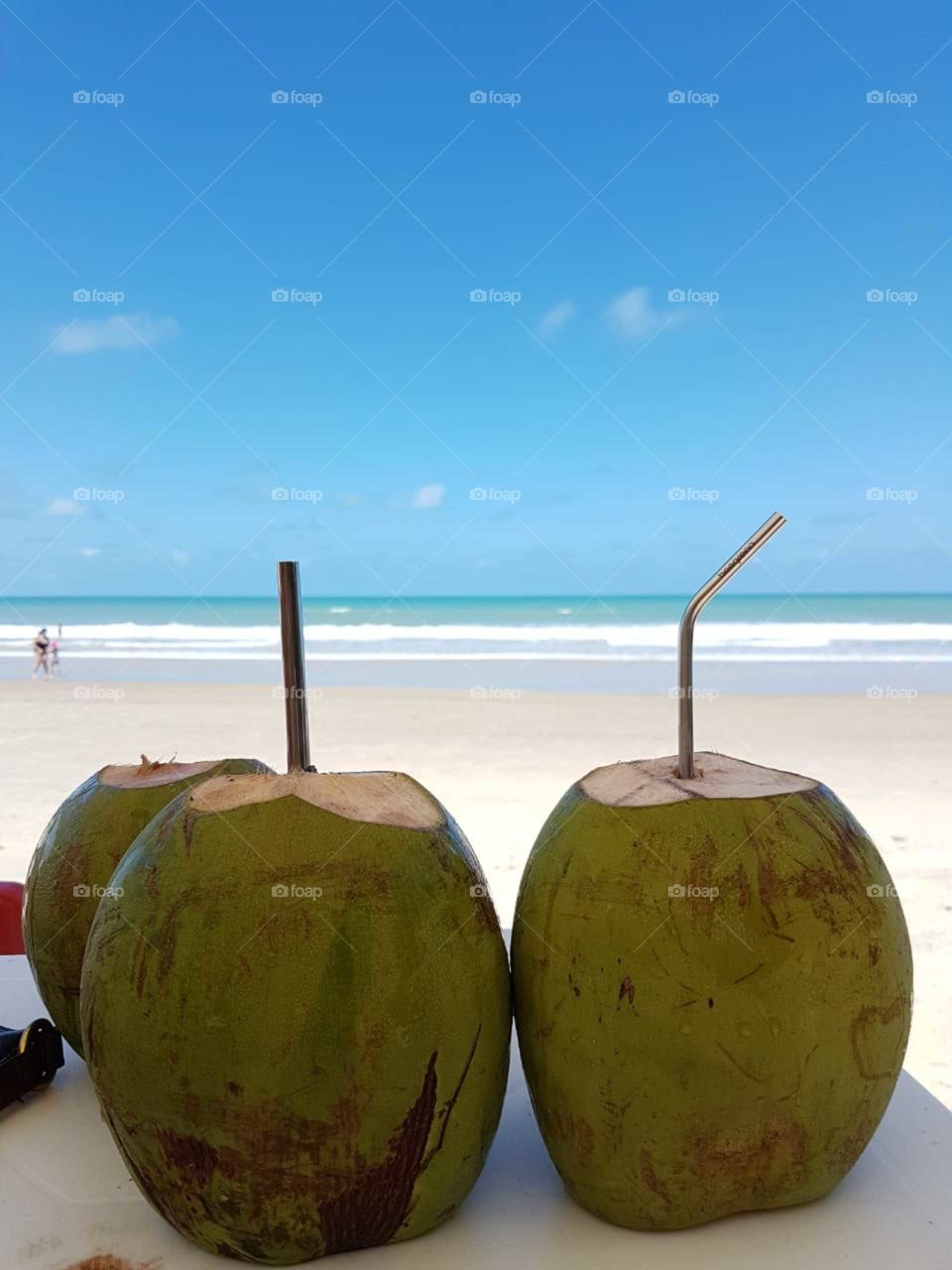 A coconut, a reusable straw, the sea and nothing else.
