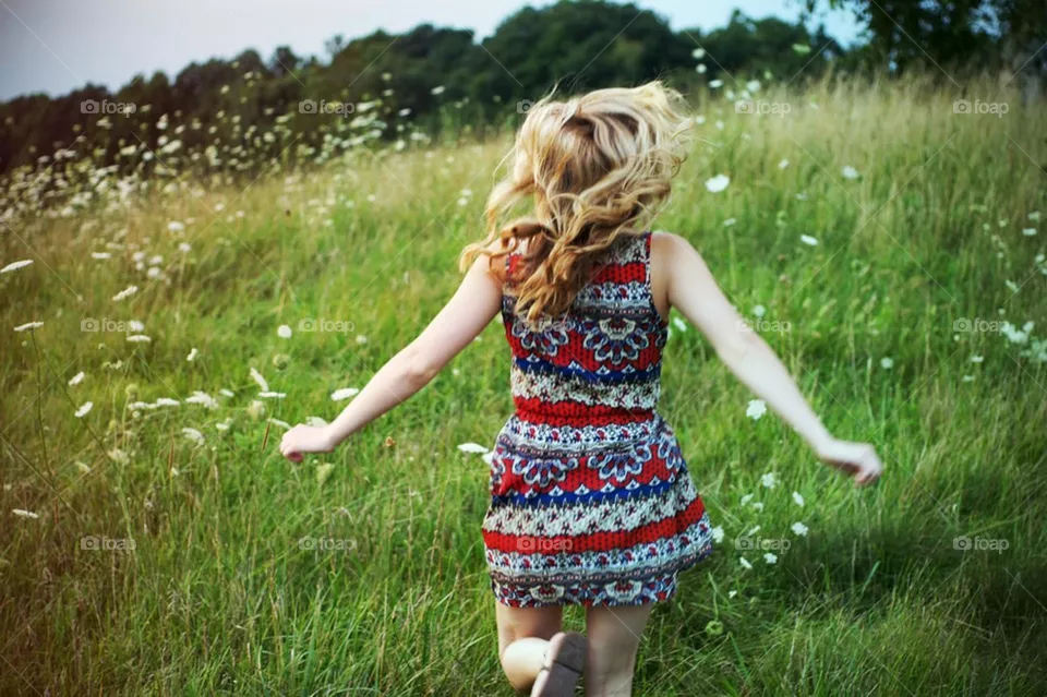 Woman running in the grass ,green grass