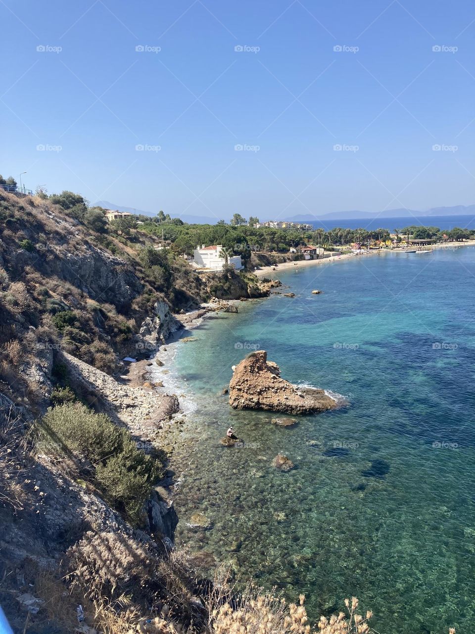 Beach time on holidays. Blue sky and tall palm trees. Sunsets and sunny days. Summertime in Kusadasi. Vacation travel in Turkey . Summer view. Sunny day during vacation