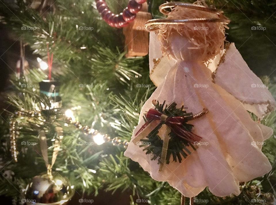 Christmas angel ornament on a Christmas tree