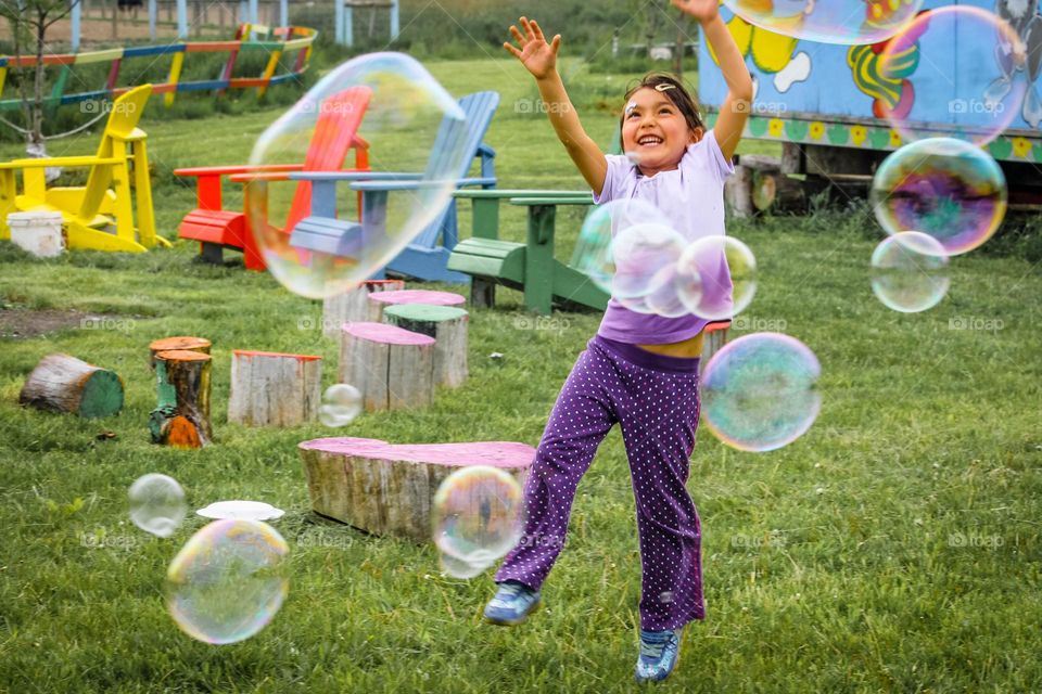 Happy girl with soapy bubbles