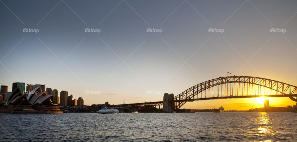 Sunset view of the Harbor Bridge and Sydney Opera House from a ferry