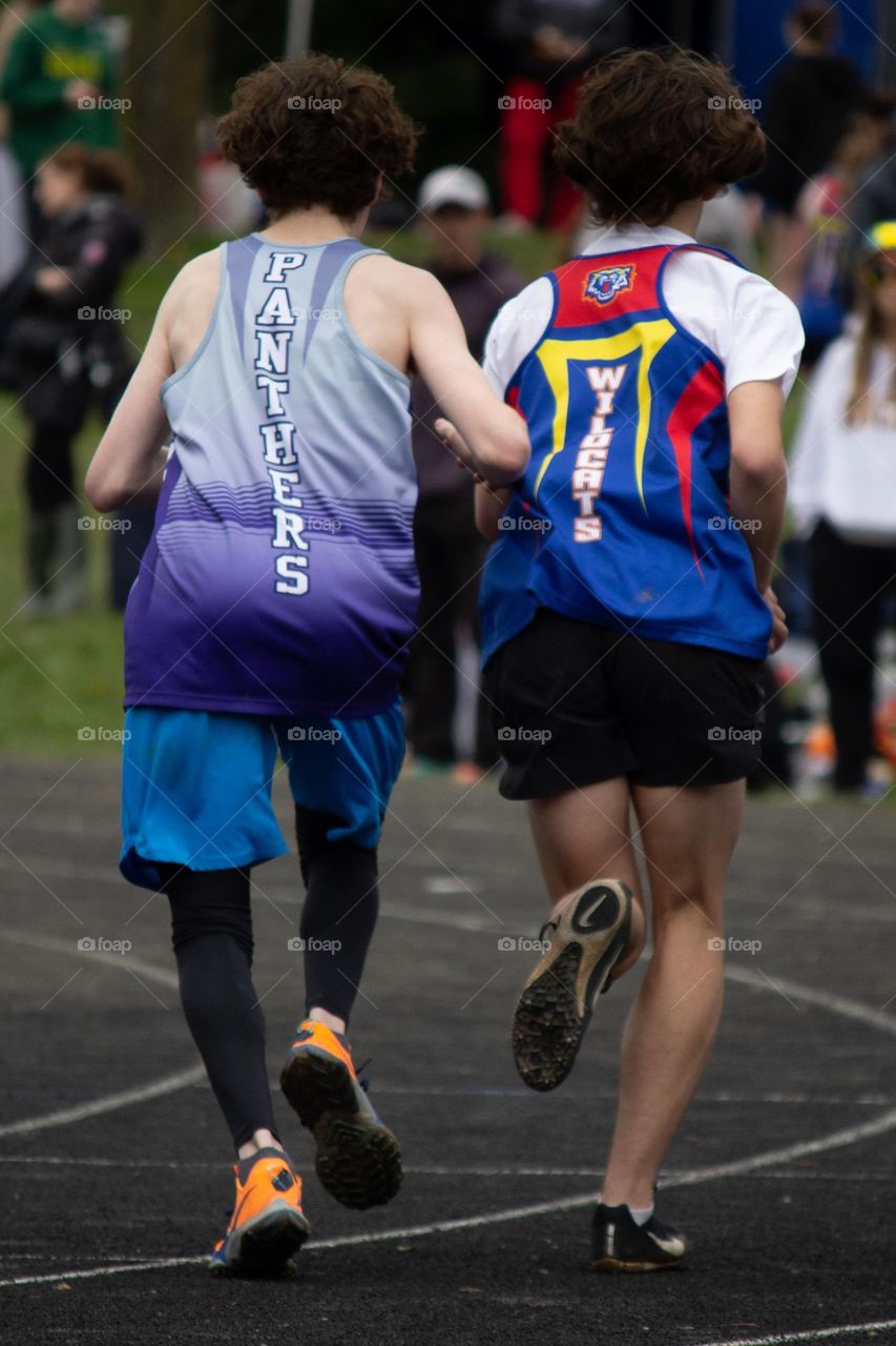 Two people running in a track race