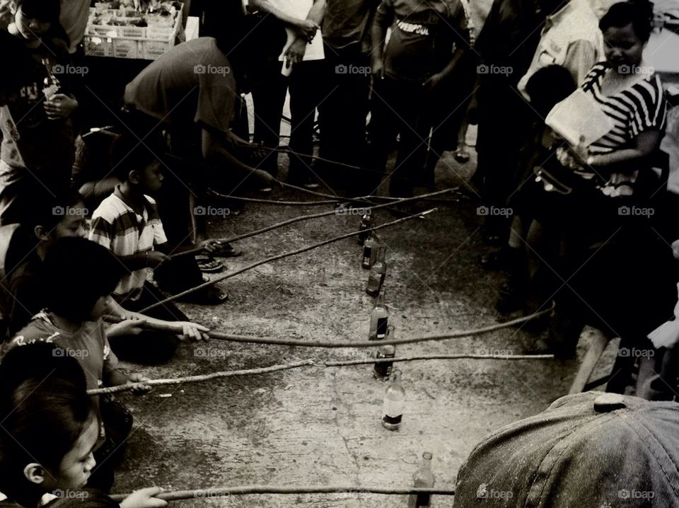 Kids playing some fish in a bottle game
