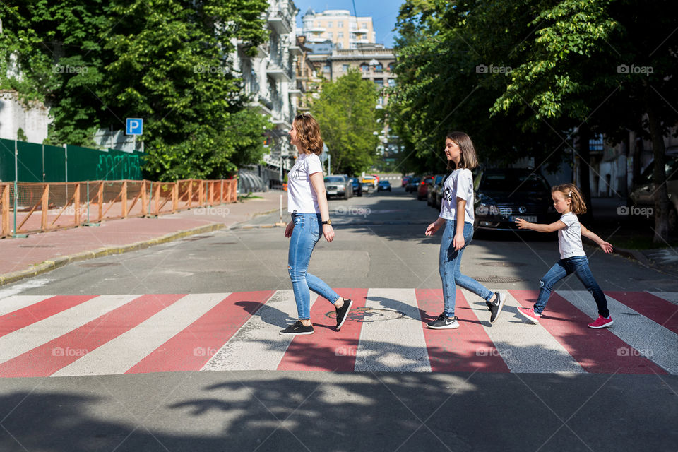 mom and daughters walk down the street after quarantine, social distance, no people, after quarantine