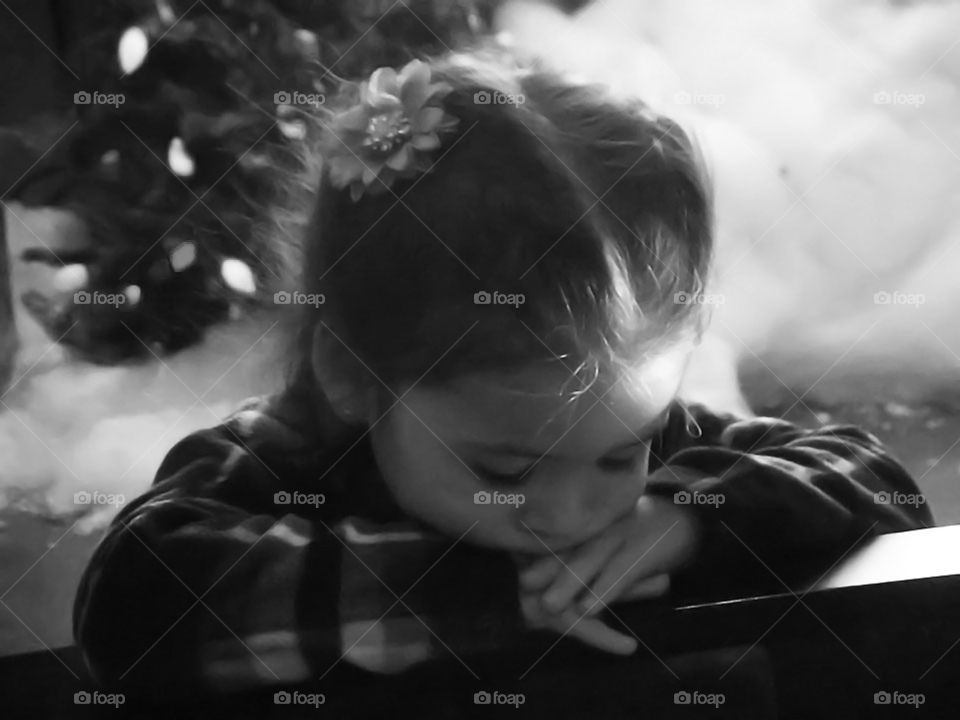 Young Girl With Head on Hands, Christmas. This photo was taken several years ago. The girl is my granddaughter. She looked so angelic in this setting.