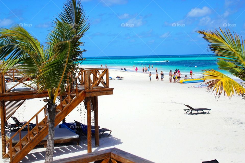 Caribbean beach with turquoise waters and people enjoying life