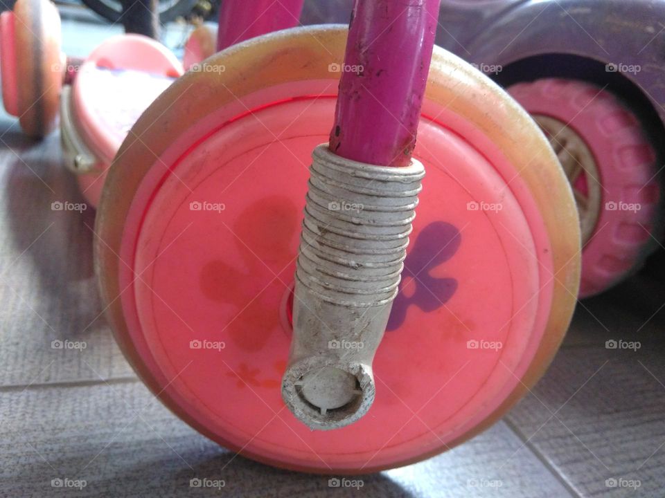 Pink wheel of old scooter toy