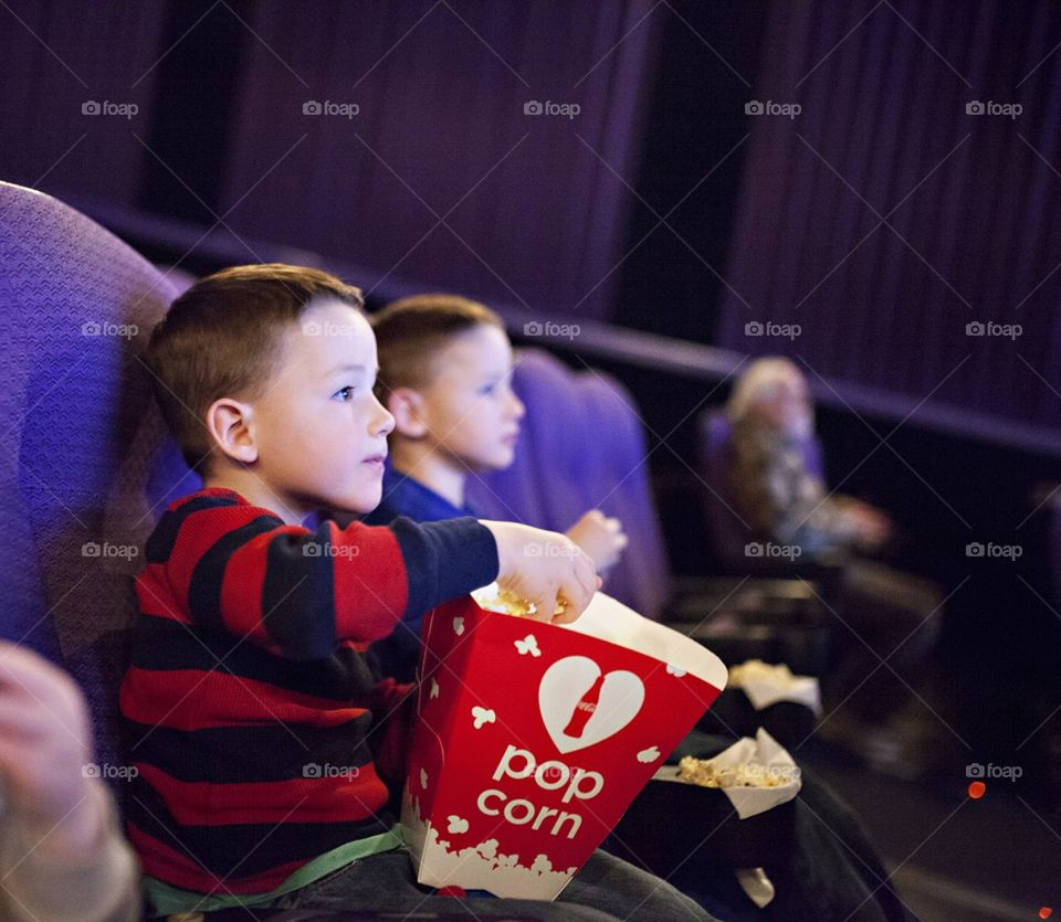 Kids in a movie theater eating popcorn