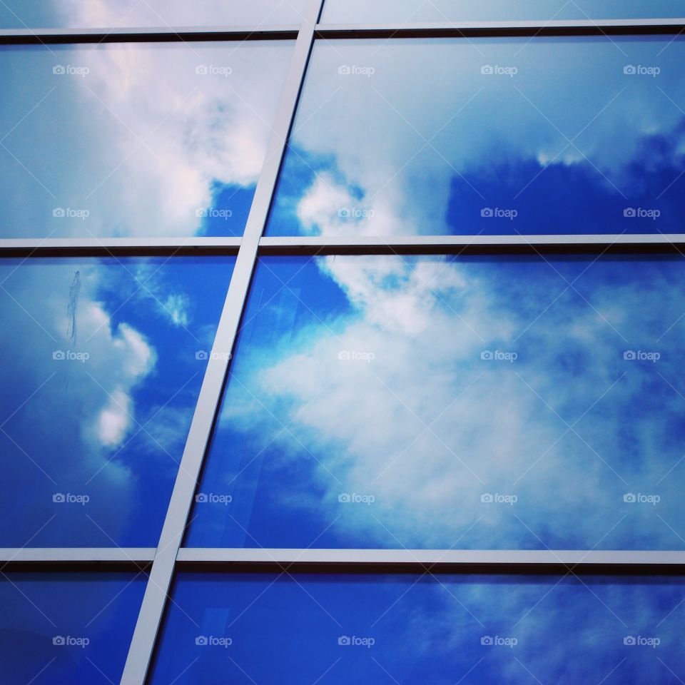 Clouds reflected on glass
