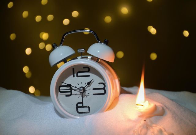 A clock with candles on the snow in the room