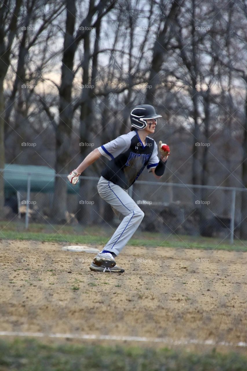 Springtime sport, Baseball player waiting for batter to hit before running to 3rd base