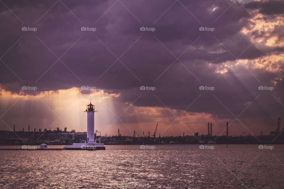 Lighthouse in the sun rays