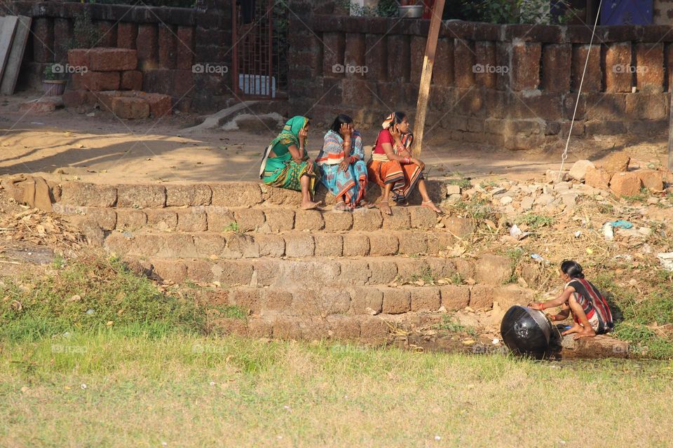 This picture describes a rural side of odisha, India,
In this picture some village women are doing their daily routine of home work and then after they relaxing and gossip about what happens going with them and their surroundings.