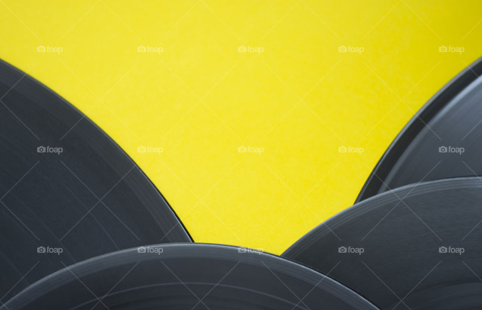 Vinyl records on yellow background 