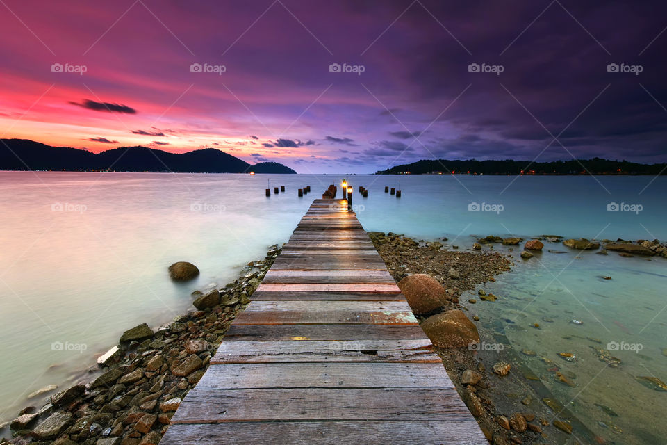 Sunset view over wooden jetty in Marina Island Malaysia