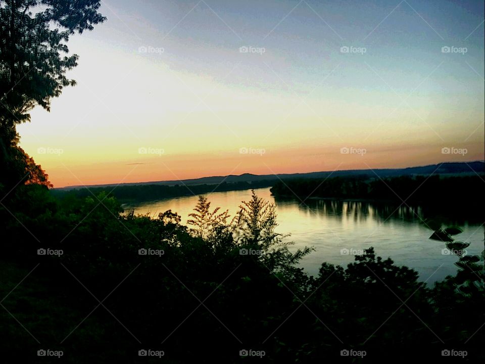 The sun sets over the Mississippi