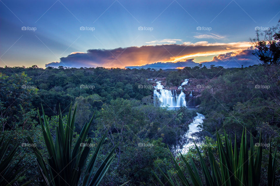 Sunset behind the waterfall