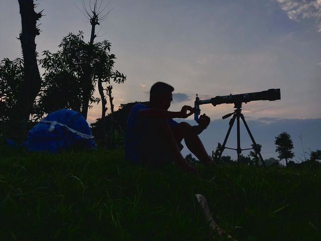silhouette of a person taking pictures of nature