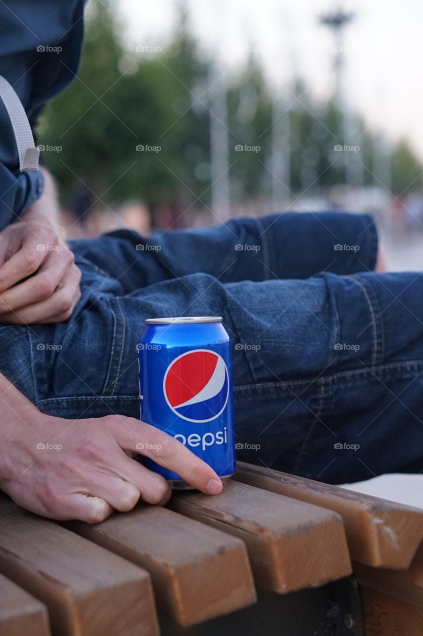 pepsi can in man's hand