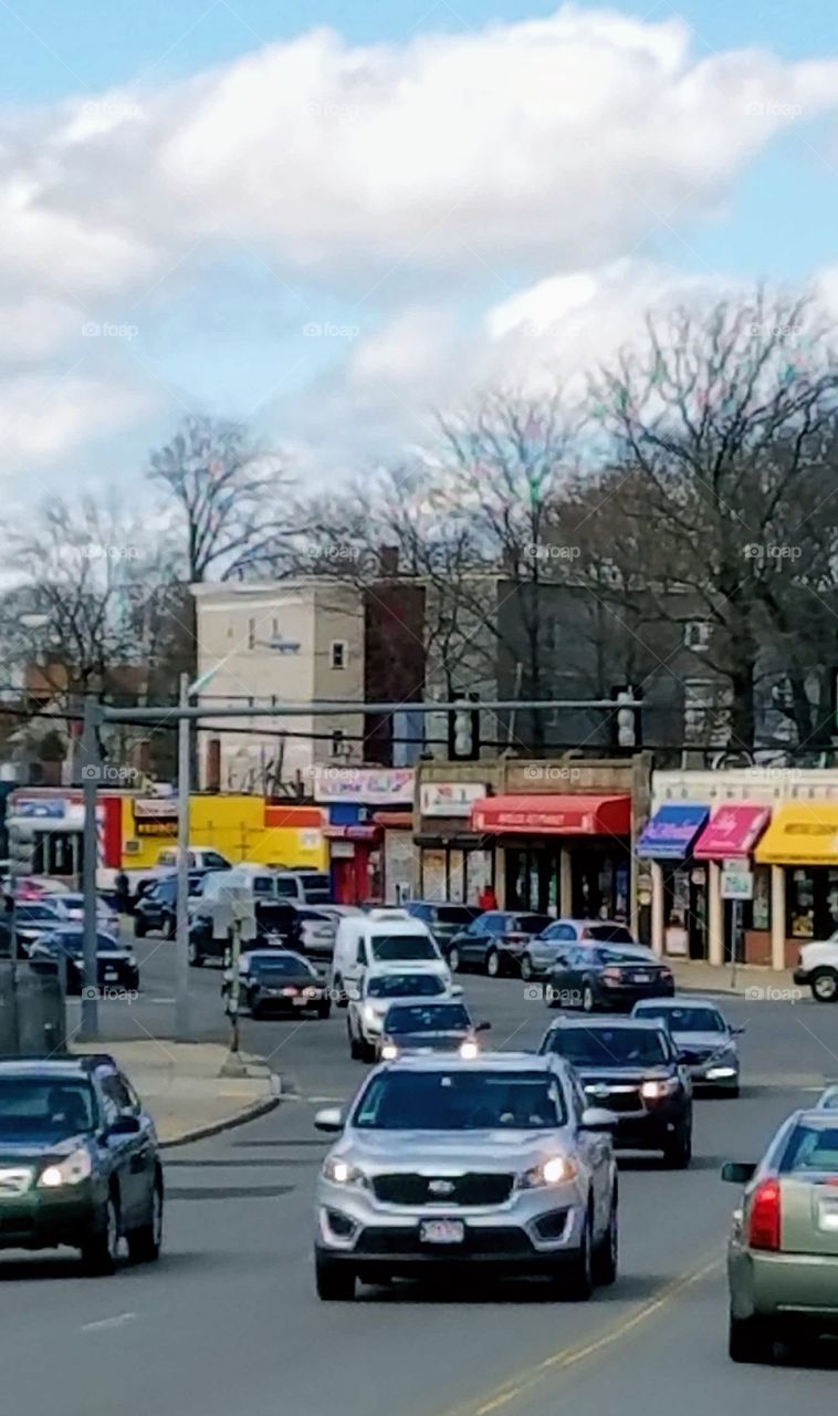 Cities of the USA
 Traffic driving through Boston, commuters driving to work. Older architecture visible for businesses.