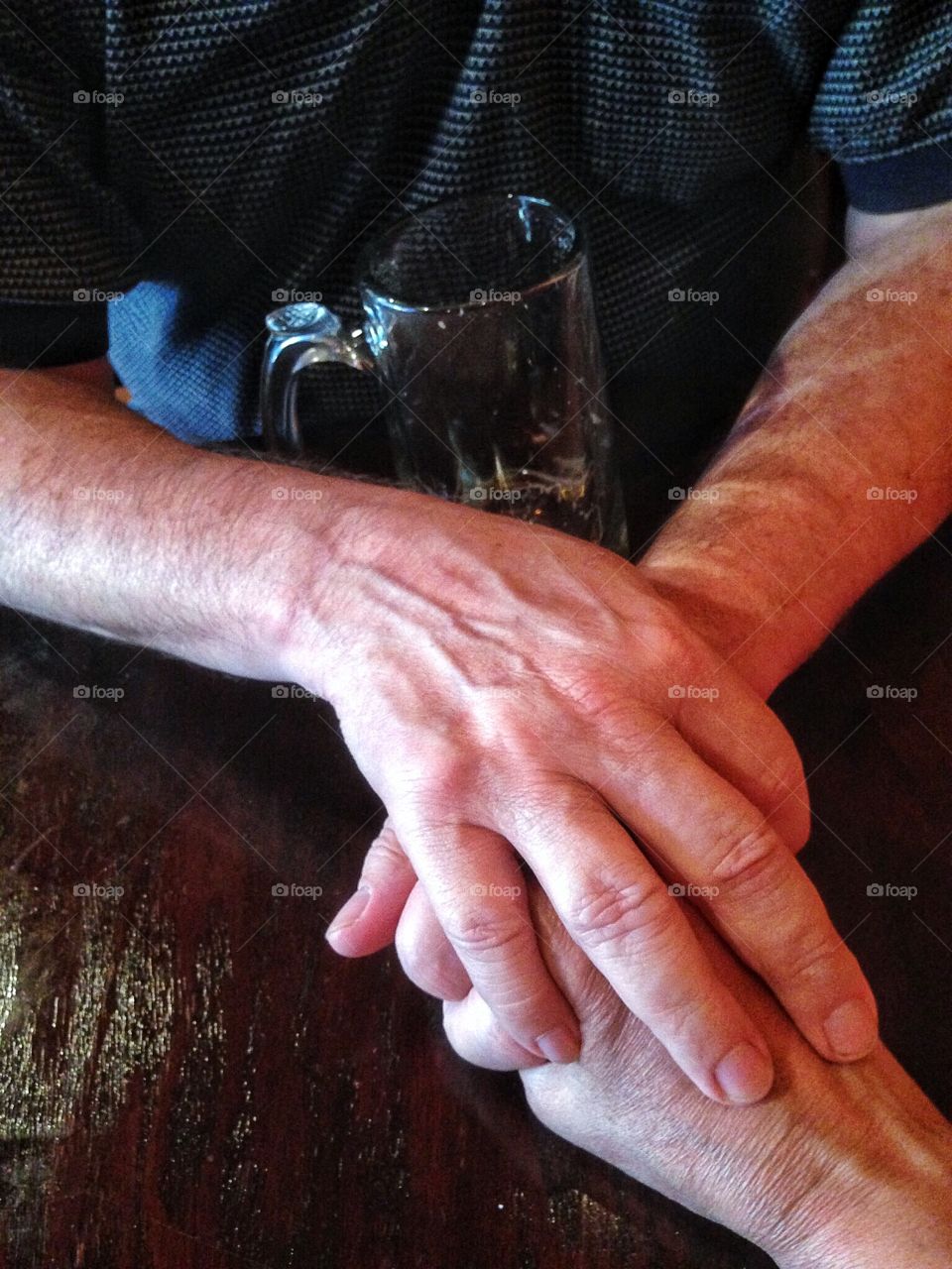 Older couple holding hands in a restaurant