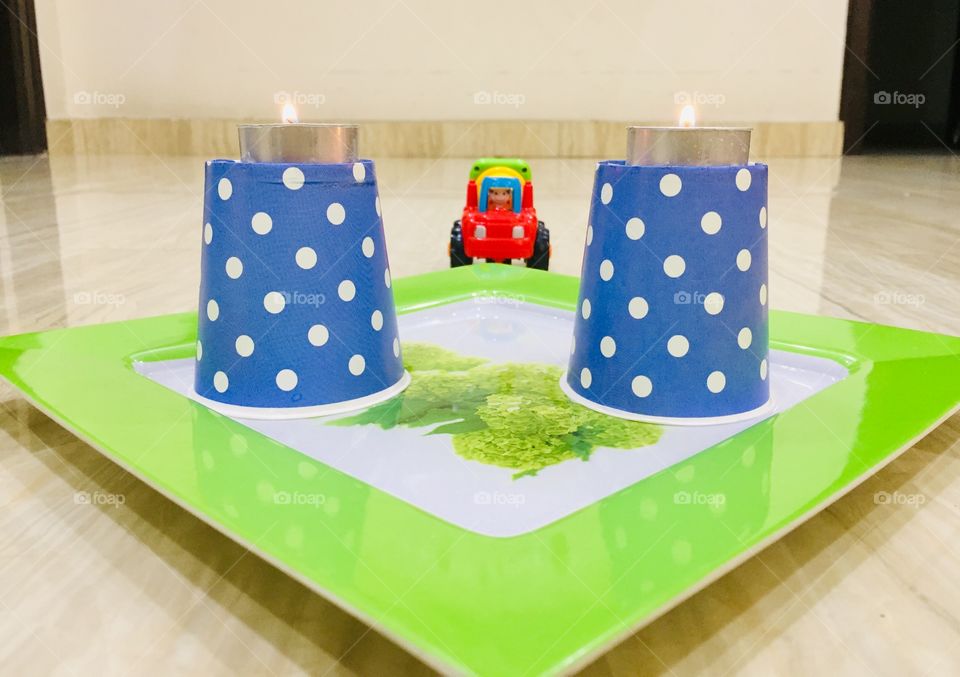 A tiny toddler in between the lights working out 