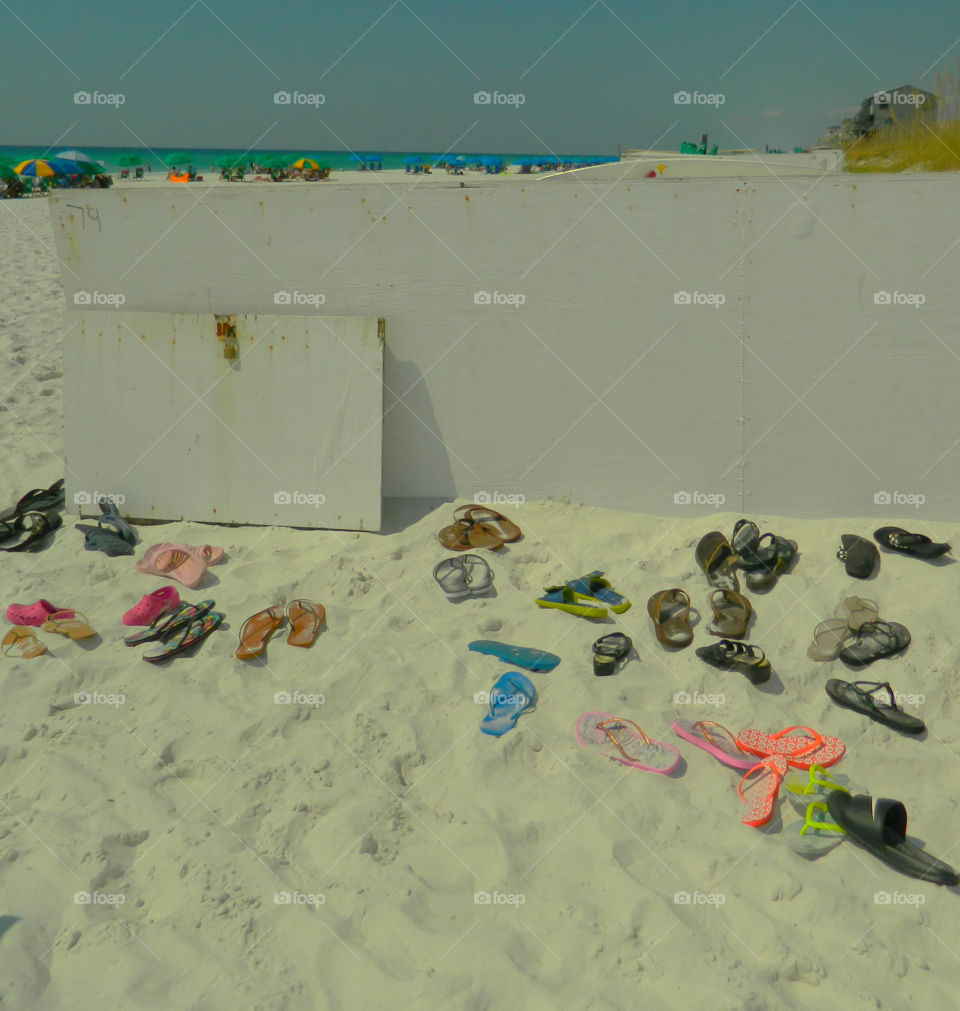 Leave your flip flops at the doorstep!
Beach goers leave their sandals at the beach entrance as they plunge into the Gulf of Mexico!