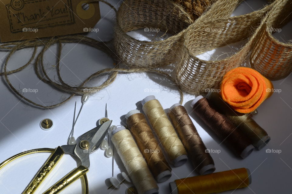 Elevated view of scissors and thread spools