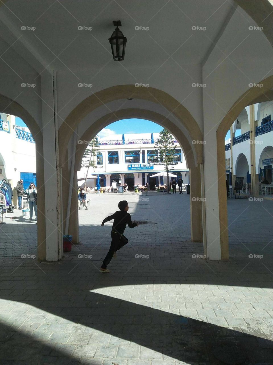 A small child runing in  the street at essaouira city in Morocco