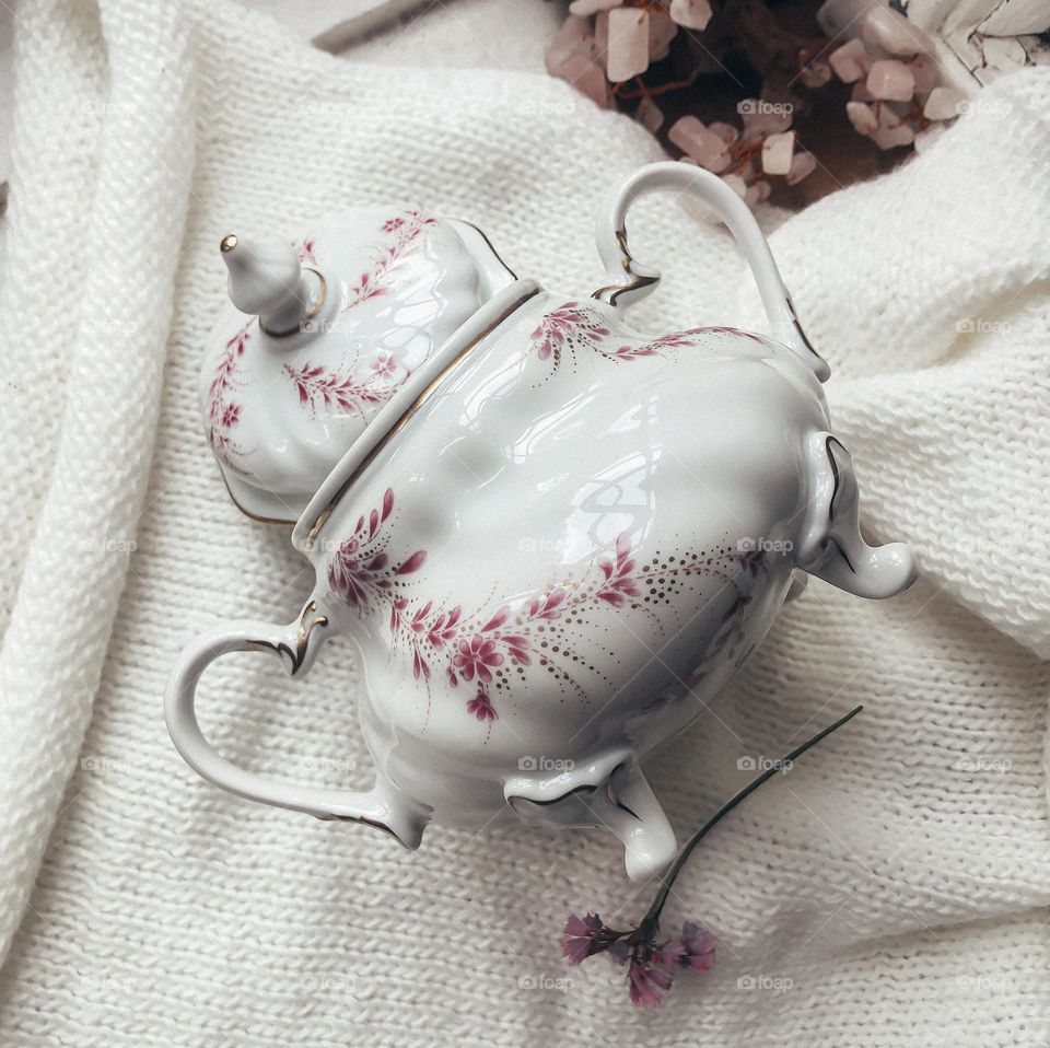 Antique porcelain sugar bowl with legs and flower ornaments 