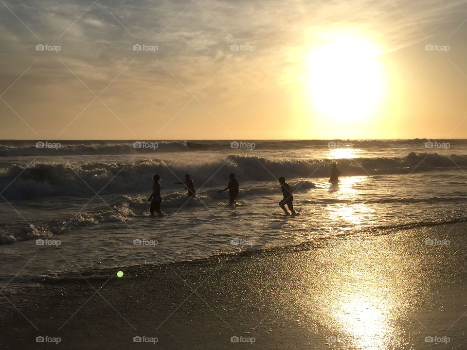 Last Days of Summer. Friends playing under a sunset in New Port Beach California. 