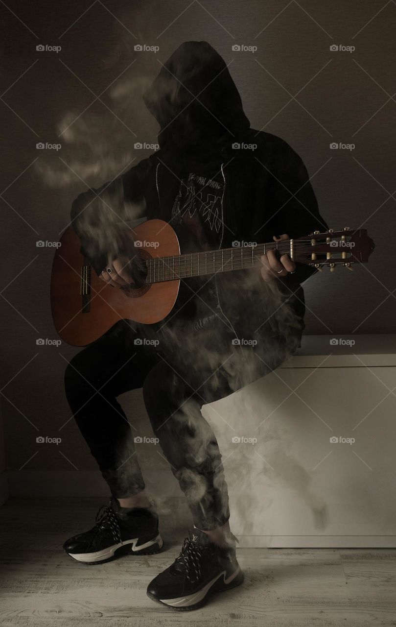 A girl with a guitar on the smoke
