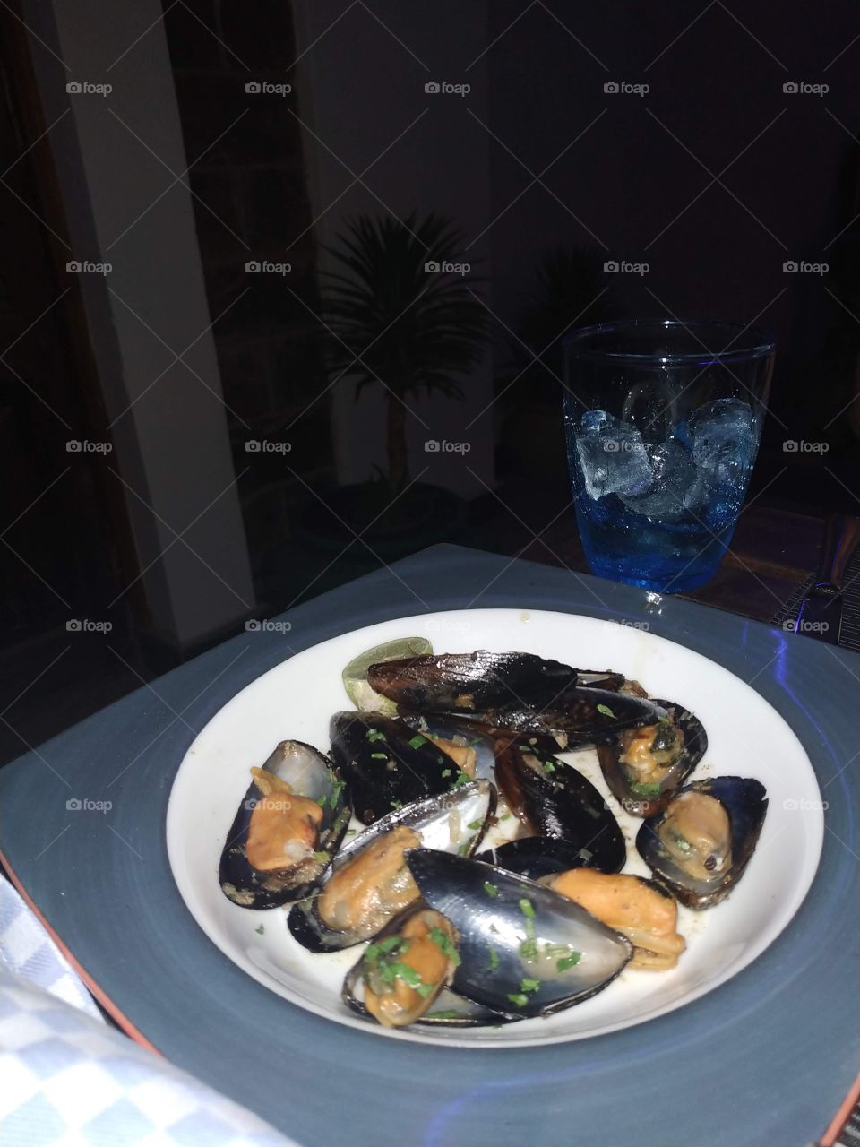 delicious grilled mussels with garlic sauce and green butter - homemade food for dinner