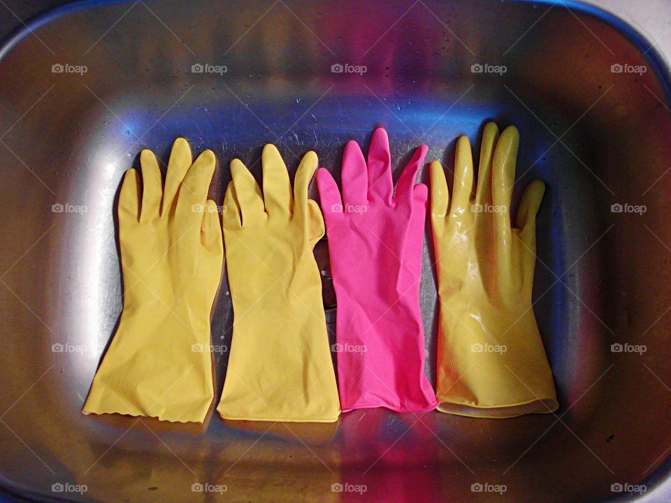 Latex gloves in a stainless steel sink
