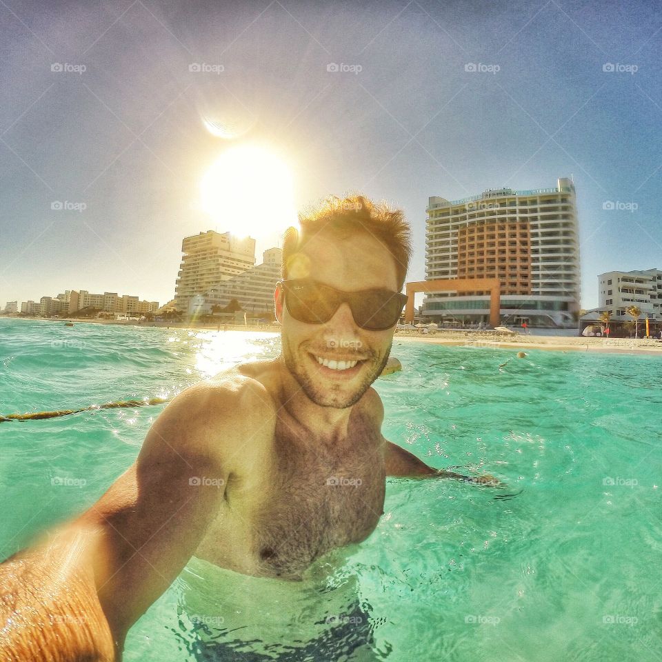 Man taking selfie in swimming pool