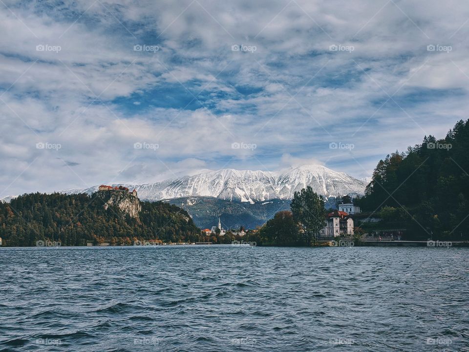 View of the snow-capped mountain peaks against the backdrop of Lake Bled.
