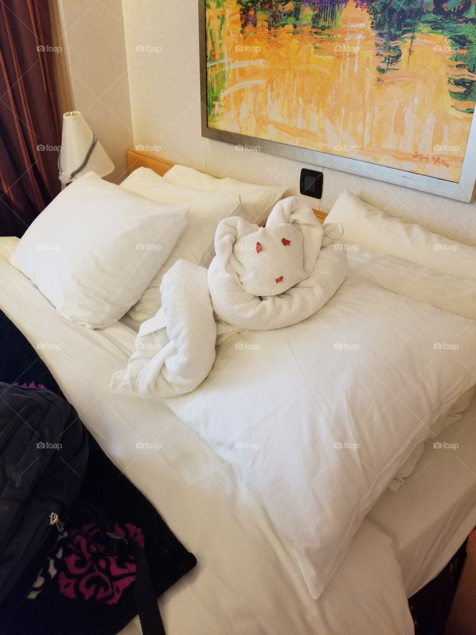 Sleepy koala bear (towel animal) resting on pillows