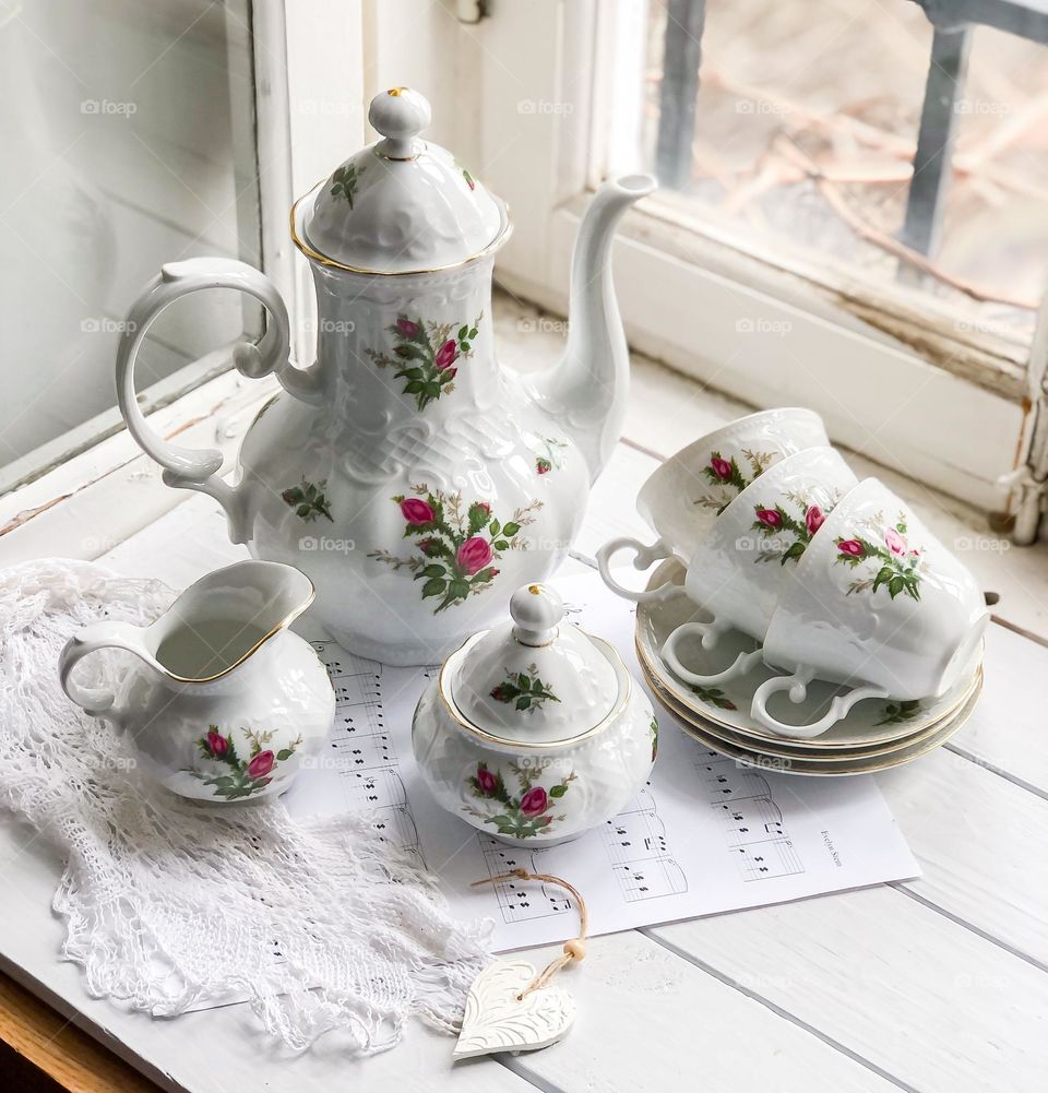 Antique porcelain service with roses and reliefs 