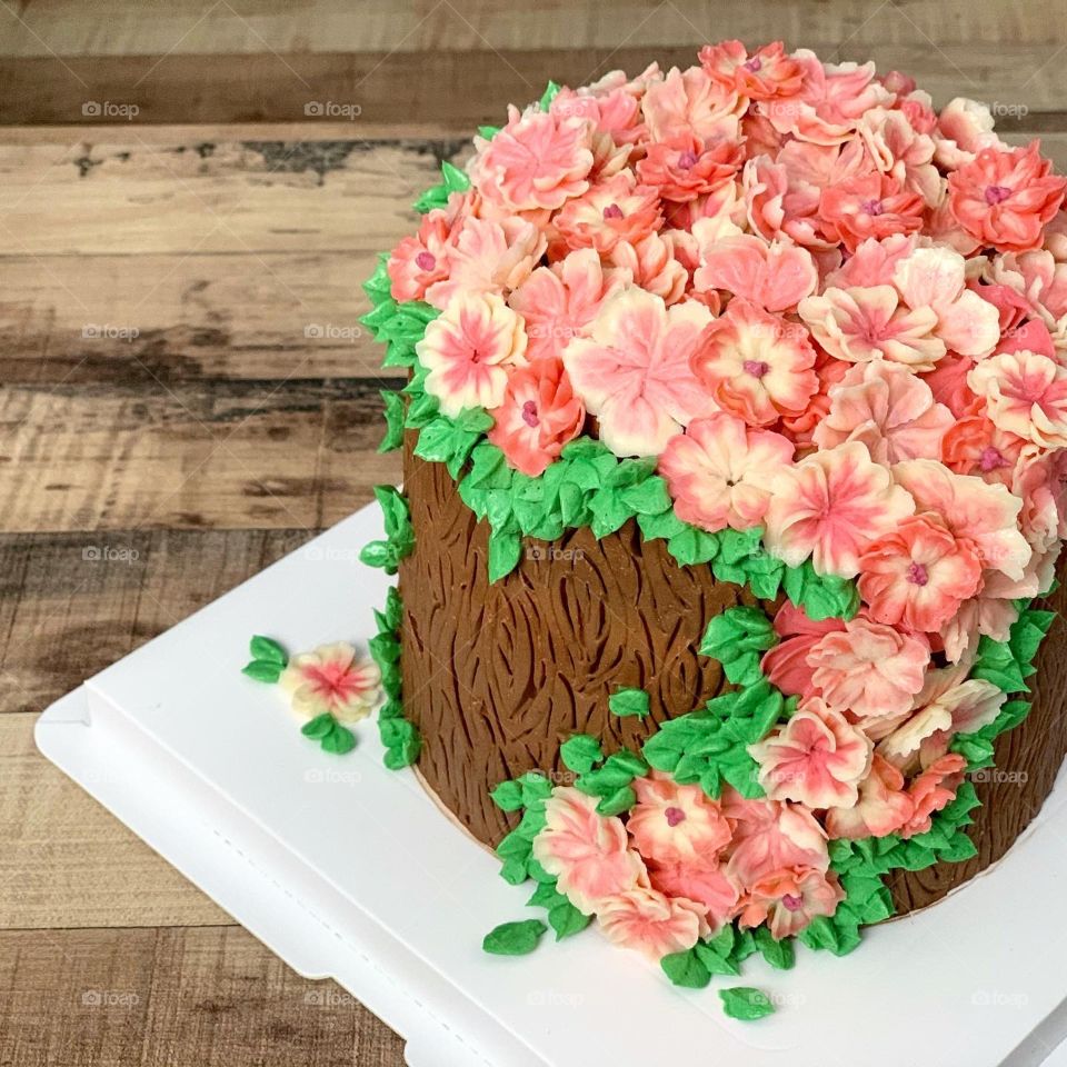 Homebake gorgeous 3D pink log edible floral buttercream cake with chocolate and vanilla and strawberry fillings