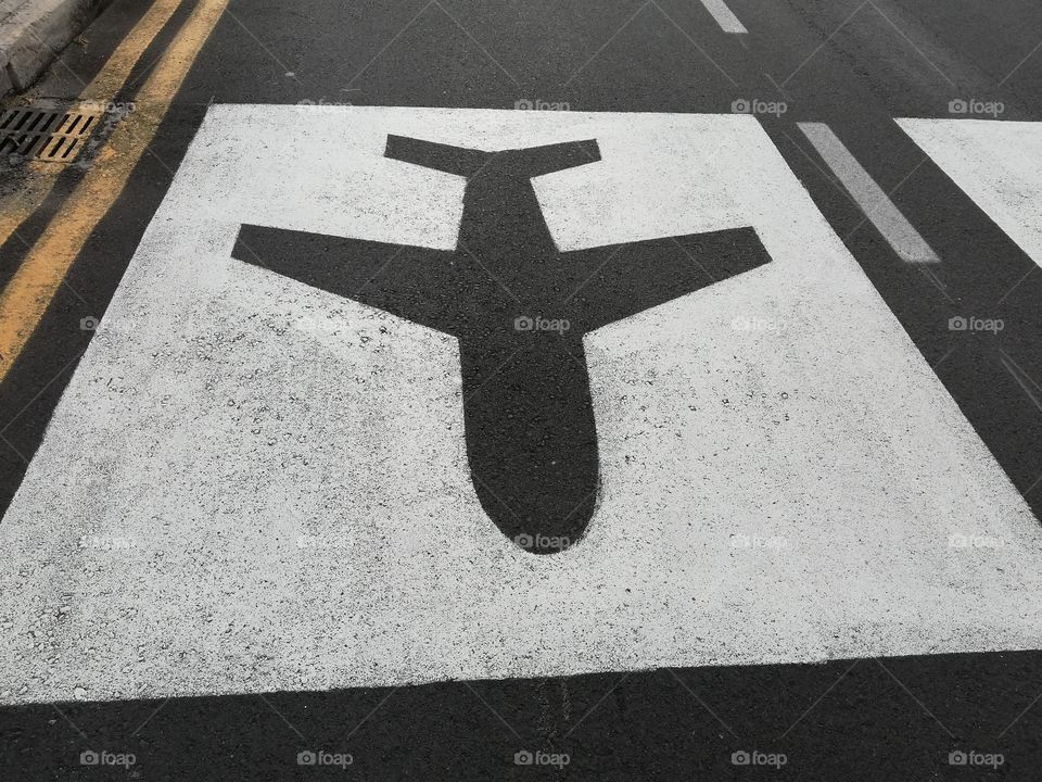 Symbol of the airplane on the asphalt