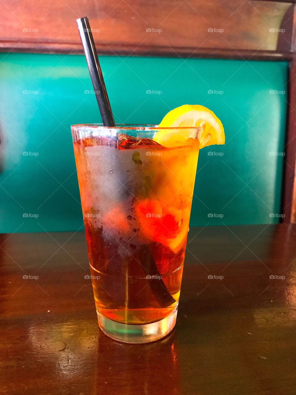 Delicious Refreshing Ice Cold Iced Tea with Lemon and a Straw 