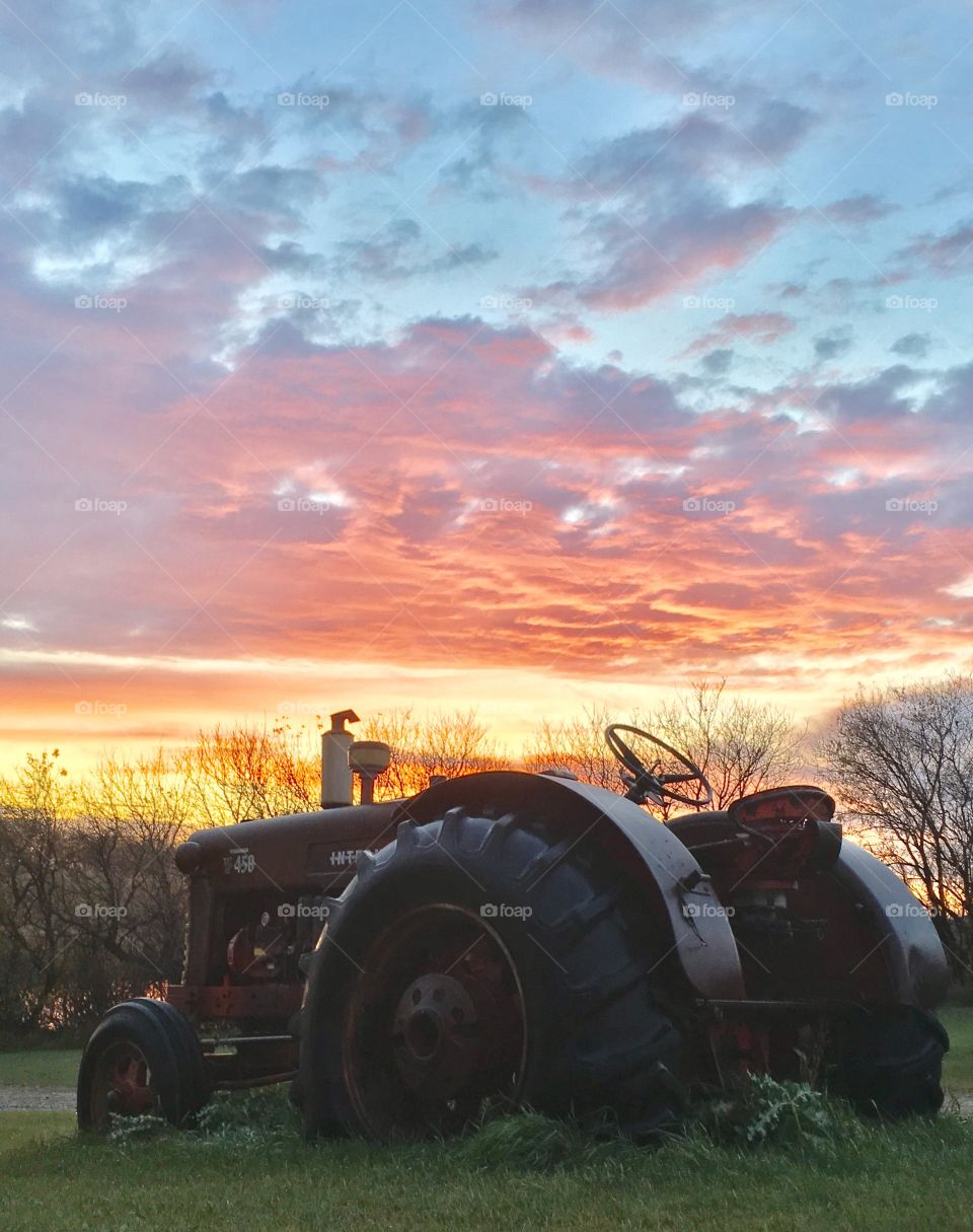 Old tractor in the sunset 