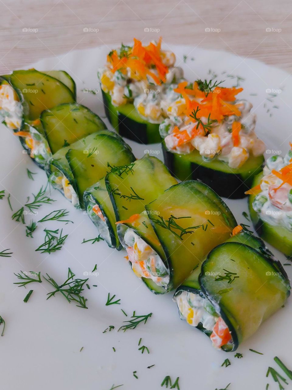 Rolled cucumbers with carrots, peas, and sour cream. It's a wonderful appetizer