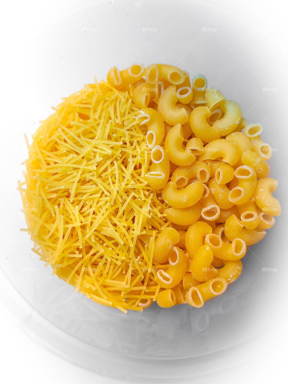 Dry angel hair pastha, split half in dry macaroni pastha